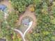 Aerial view showing a house nestled in a wooded lot with a long driveway at 1797 Star Point Rd, Carrollton, GA 30116