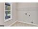 Bright laundry room features built-in shelving and window at 1797 Star Point Rd, Carrollton, GA 30116