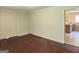 Living room with hardwood floors and view into kitchen area at 1030 Mundys Mill Rd, Jonesboro, GA 30238