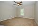 Bedroom with ceiling fan and neutral carpeting at 1551 Adrian Dr, Riverdale, GA 30296