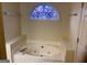 Bathroom with jetted tub and stained glass window at 362 Arbor Ridge Pkwy, Mcdonough, GA 30253