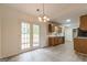 Kitchen with wood cabinets, granite countertops and French doors to patio at 216 Colemans Bluff Dr, Woodstock, GA 30188