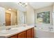 Main bathroom with double sinks and garden tub at 3463 Madison Farm Way, Snellville, GA 30039