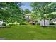 Landscaped front yard with large trees and spacious lawn at 3463 Madison Farm Way, Snellville, GA 30039