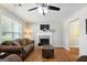 Bright living room features a fireplace and hardwood floors at 3463 Madison Farm Way, Snellville, GA 30039