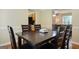 Dining room with dark wood table and six chairs at 3463 Madison Farm Way, Snellville, GA 30039