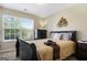 Main bedroom with a sleigh bed and large window at 3463 Madison Farm Way, Snellville, GA 30039