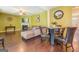 Open living area with hardwood floors, and a view of kitchen and dining area at 445 Brickstone Way, Covington, GA 30016