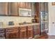 Dark wood cabinets, granite countertops and stainless steel appliances at 445 Brickstone Way, Covington, GA 30016