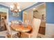 Bright dining room features a table for six and access to the hallway at 445 Brickstone Way, Covington, GA 30016