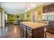 Spacious kitchen features an island, stainless steel appliances, and hardwood floors at 445 Brickstone Way, Covington, GA 30016