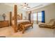 Large main bedroom with a king-size bed and sitting area at 445 Brickstone Way, Covington, GA 30016