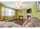 Living room with green walls, fireplace, and sectional sofa at 445 Brickstone Way, Covington, GA 30016