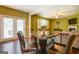 Bright dining area with granite-top table and four chairs, adjacent to living room at 445 Brickstone Way, Covington, GA 30016