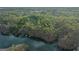 Aerial view of a wooded lot on the lake with neighboring houses at 5325 Browns Bridge Rd, Cumming, GA 30041