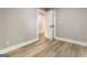 Small bedroom with hardwood floors and access to hallway at 1510 Mims Sw St, Atlanta, GA 30314