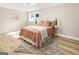 Bright bedroom with light pink bedding and wood floors at 1510 Mims Sw St, Atlanta, GA 30314