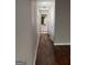 Long hallway with hardwood floors leading to bathroom at 449 Kara Ln, Mcdonough, GA 30253