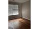 Bright bedroom with hardwood floors and large window at 449 Kara Ln, Mcdonough, GA 30253