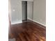Spacious bedroom with hardwood floors and mirrored closet at 449 Kara Ln, Mcdonough, GA 30253