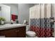 Clean bathroom with a patterned shower curtain and dark wood vanity at 132 Sunflower Meadows Dr, Mcdonough, GA 30252
