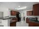 Modern kitchen features dark wood cabinets, granite countertops, and tile flooring at 132 Sunflower Meadows Dr, Mcdonough, GA 30252