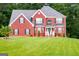 Two-story brick house with a landscaped lawn and mature trees at 132 Sunflower Meadows Dr, Mcdonough, GA 30252