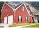 Brick house with a two car garage and nicely manicured lawn at 132 Sunflower Meadows Dr, Mcdonough, GA 30252