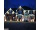 Two-story brick home with professionally installed landscape lighting at 132 Sunflower Meadows Dr, Mcdonough, GA 30252