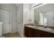 Double vanity bathroom with a large mirror and dark wood cabinets at 132 Sunflower Meadows Dr, Mcdonough, GA 30252