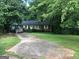 Brick ranch house with a large front yard and driveway at 2093 Wildrose Dr, Decatur, GA 30032