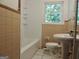 Bathroom with beige tile and a bathtub shower combo at 2093 Wildrose Dr, Decatur, GA 30032