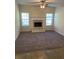 Living room featuring a fireplace and large windows at 7495 St David St, Fairburn, GA 30213
