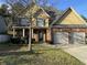 Two-story house with double garage and landscaping at 7495 St David St, Fairburn, GA 30213