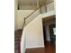 Elegant staircase with wooden railings and neutral walls at 7495 St David St, Fairburn, GA 30213