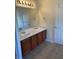 Double vanity bathroom with a large mirror and tile flooring at 7495 St David St, Fairburn, GA 30213
