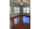 Well-lit bedroom with hardwood floors and ceiling fan at 7495 St David St, Fairburn, GA 30213