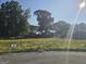 Vacant lot with trees and street view at 5716 Laney Dr, Rex, GA 30273