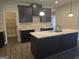 Modern kitchen with granite island and dark cabinets at 5717 Laney Dr, Rex, GA 30273