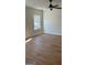 Bedroom with hardwood floors, large window, and ceiling fan at 4127 James Lake Dr, Conley, GA 30288