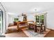 Open dining area with wood table, chandelier, and access to living room at 12 Fairway Ln, Peachtree City, GA 30269