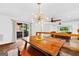 Dining area with wood table, chandelier and view of living room at 12 Fairway Ln, Peachtree City, GA 30269