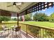 Inviting front porch with wooden railings, offering a relaxing view of the green lawn at 12 Fairway Ln, Peachtree City, GA 30269