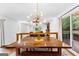 Bright dining area with wood table and access to living room and deck at 12 Fairway Ln, Peachtree City, GA 30269