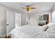 Spacious bedroom with ceiling fan and access to bathroom at 12 Fairway Ln, Peachtree City, GA 30269