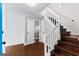 Spacious entryway with staircase and two closed doors at 12 Fairway Ln, Peachtree City, GA 30269