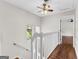 Upstairs hallway with a white railing and hardwood floors at 12 Fairway Ln, Peachtree City, GA 30269