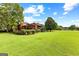Property showcasing home and large lawn at 12 Fairway Ln, Peachtree City, GA 30269