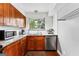 Well-equipped kitchen with ample cabinetry and a corner sink at 12 Fairway Ln, Peachtree City, GA 30269