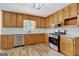 Kitchen with wood cabinets, granite countertops, and stainless steel appliances at 2752 Poplar Rd, Sharpsburg, GA 30277